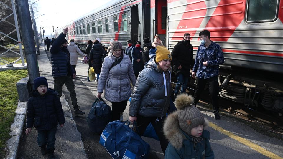 People, who were evacuated from separatist-controlled regions in eastern Ukraine, board a train before leaving the city of Taganrog in the Rostov region in Rostov, Russia following their evacuation.