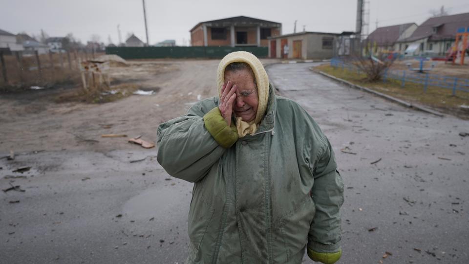 A woman cries outside houses damaged by a Russian airstrike, according to locals, in Gorenka, outside the capital Kiev.