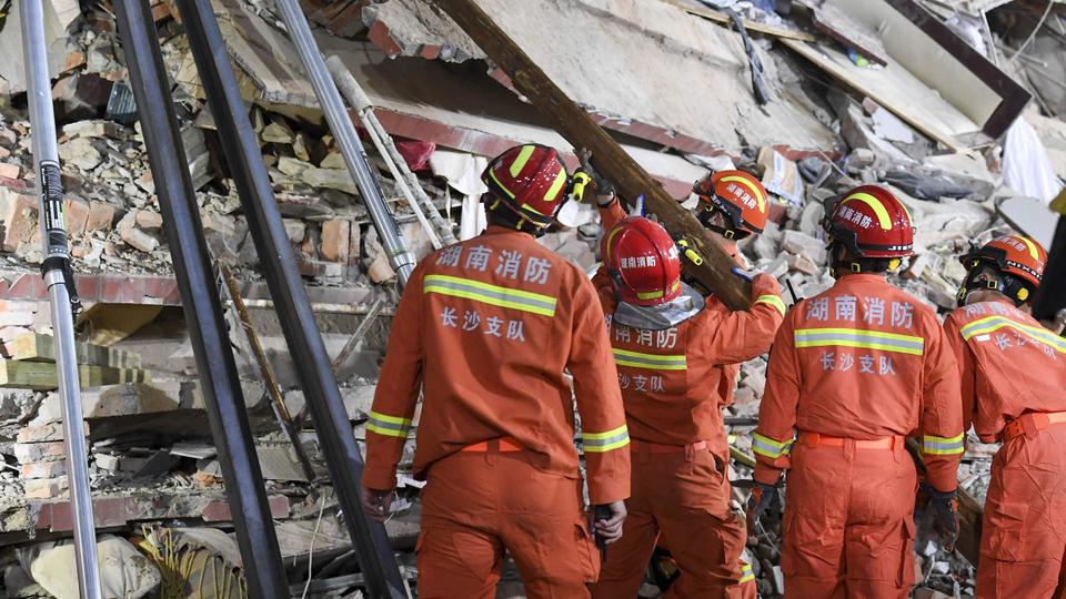 Several trapped after eight-storey building in China comes crashing down
