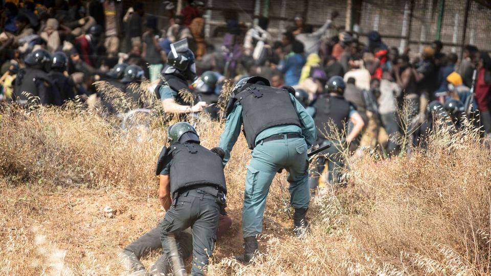 Many migrants and refugees are detained by police officers on Spanish soil after crossing the fences separating the Spanish enclave of Melilla from Morocco in Melilla, Spain.