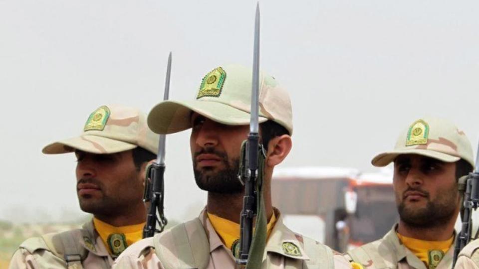 Iranian soldiers pose with bayonets during a military parade.