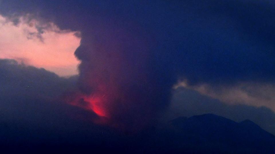 Footage on Japan’s NHK public television showed orange flames flashing near the crater and dark smoke of ash billowing from the mountaintop high up into the night sky.