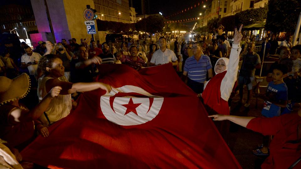 Saied's supporters drove cars in procession through central Tunis, waving flags and singing the national anthem.