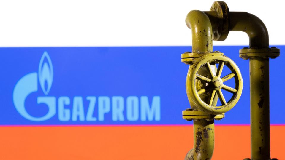 A 3D printed natural gas pipeline is placed in front of displayed Gazprom logo and Russian flag in this illustration taken February 8, 2022.