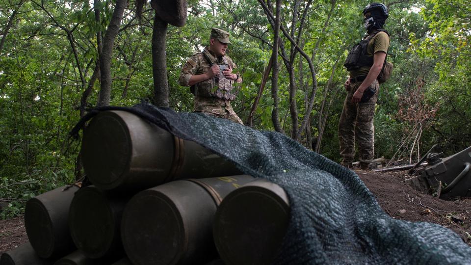 Ukrainian servicemen stand near shells for an M777 howitzer at a position on a front line, as Russia's attack on Ukraine continues, in Kharkiv region, Ukraine, August 1, 2022.