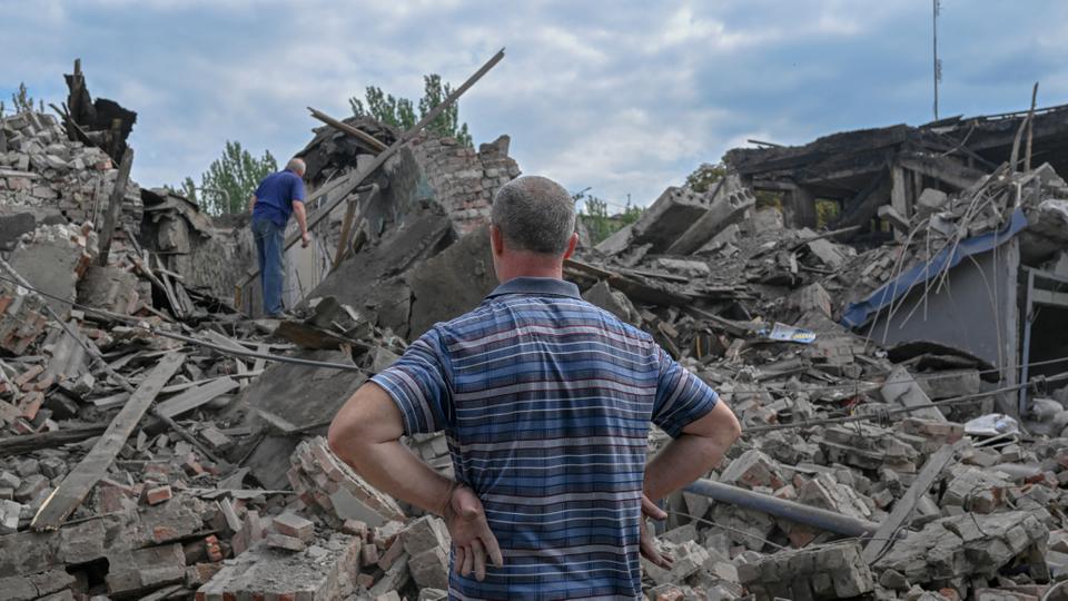 A local resident looks at the rubble of a destroyed building in Toretsk, eastern Ukraine.