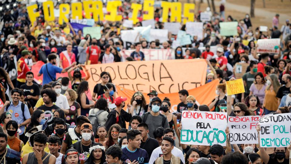 Thousands hold up banners denouncing Bolsonaro and proclaiming: 