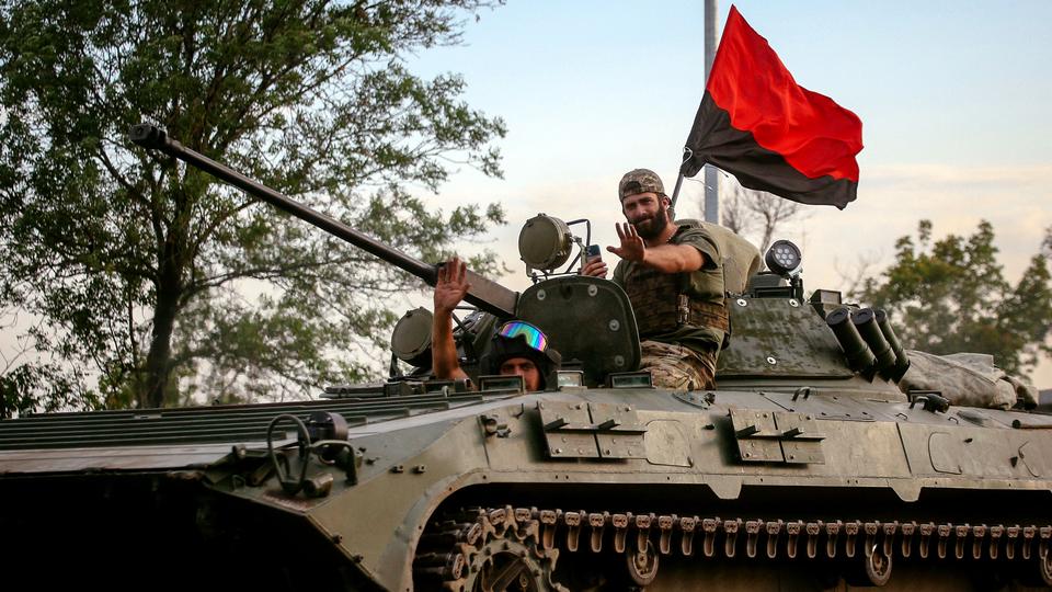 Ukrainian soldiers ride an armoured personnel carrier in Donetsk region as fighting rages in eastern Ukraine.