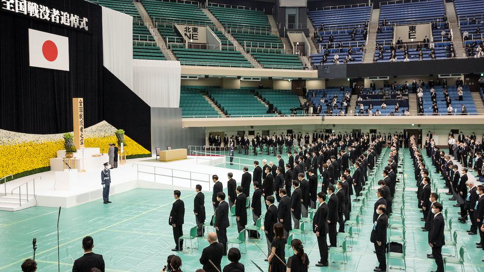 Some 900 participants observed a minute of silence at noon during the ceremony held at the Budokan arena.