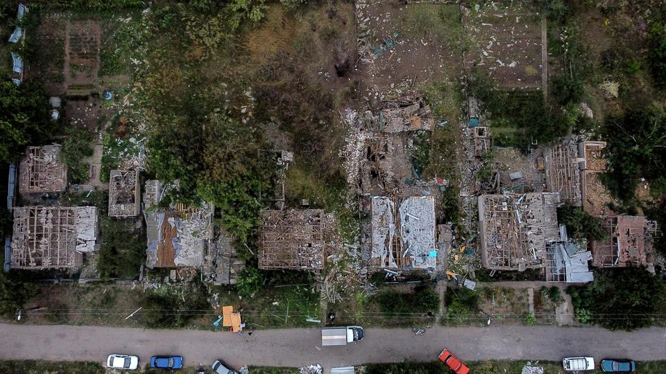 A crater left after a Russian rocket attack on Friday night which killed at least three people is seen next to damaged homes in Kramatorsk, Donetsk region in eastern Ukraine on August 13, 2022.