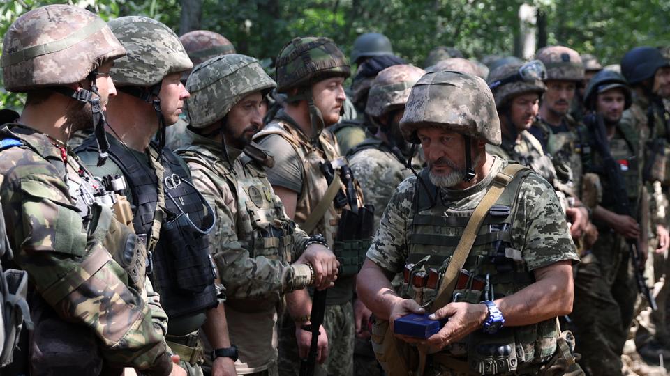 A Ukrainian soldier holds an award during a ceremony at a position along the front line in the Donetsk region amid Russia's offensive in Ukraine.