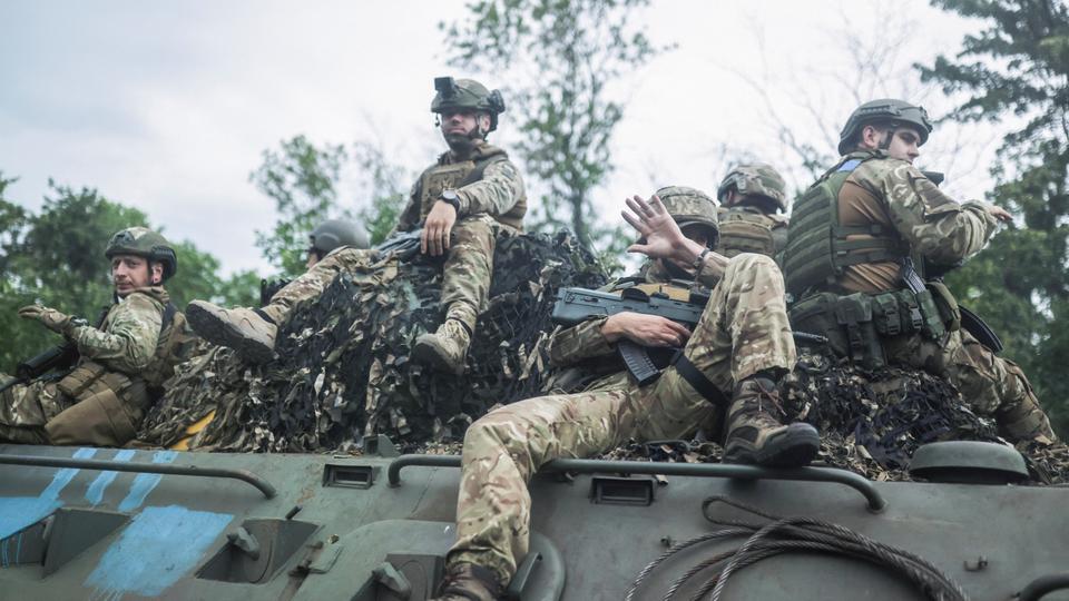 Ukrainian servicemen travel on a Wheeled-BTR fighting vehicle near Bakhmut in the Donetsk region.