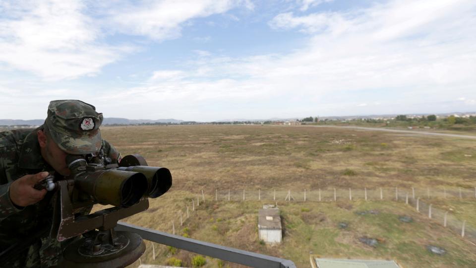 An Albanian military member uses binoculars in Kucova Air Base in Kucova, Albania in this file photo taken on October 3, 2018.