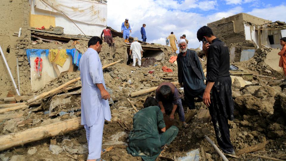 People clean up their damaged homes after the heavy flood in Khushi district of Logar, Afghanistan.