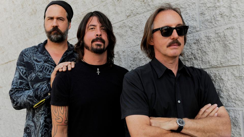 In this September 6, 2011 photo, Krist Novoselic, left, and Dave Grohl, centre, former members of the band Nirvana, pose with Butch Vig, producer of the band's landmark 1991 album 