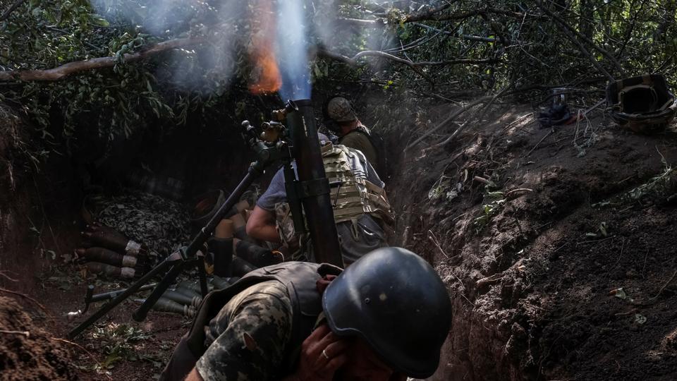 Ukrainian servicemen fire a mortar on the front line, as Russia's attack on Ukraine continues, in Donetsk region.