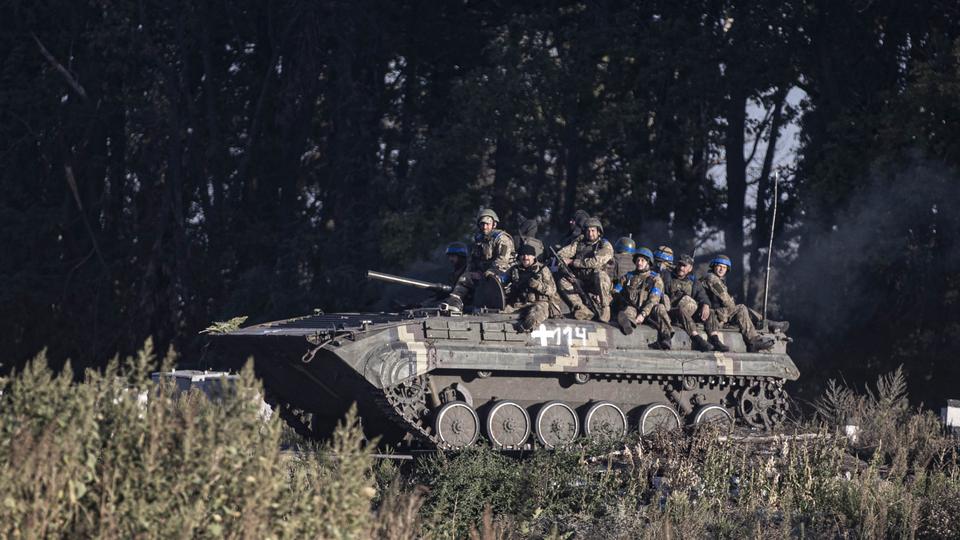 Ukrainian officials shared photos showing troops raising the nation's flag over the city housing the main railway hub that has supplied Russian forces in northeastern Ukraine.