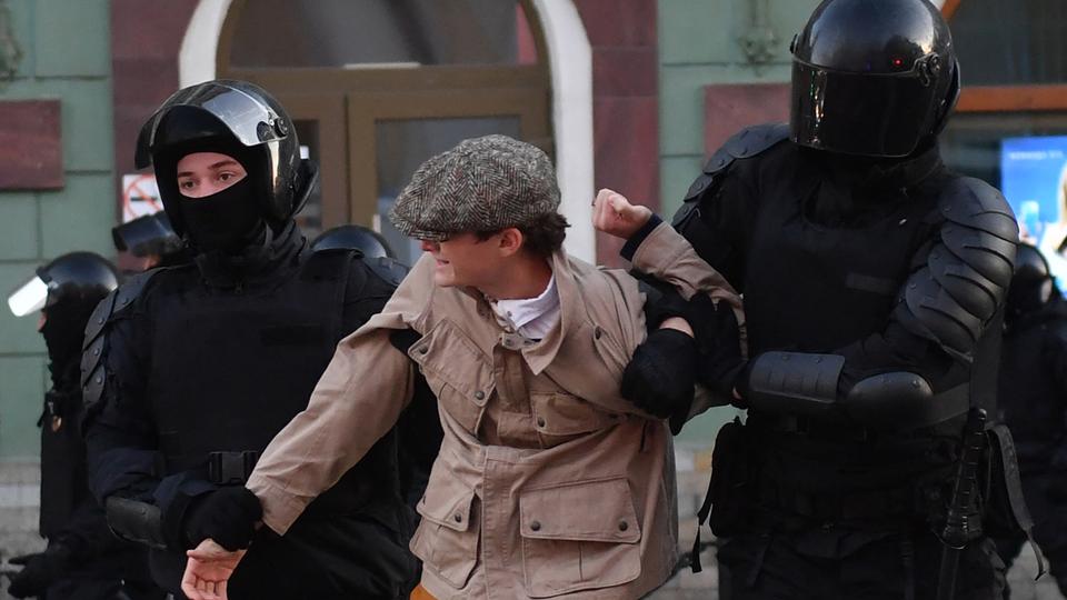 Police officers detain a man in Saint Petersburg on September 24, 2022, following calls to protest against the partial mobilisation announced by the Russian President.