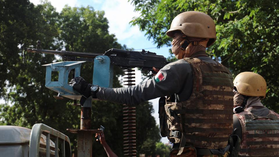 Soldiers of Burkina Faso's new junta stand guard in an armoured vehicle in capital Ouagadougou on October 2, 2022.