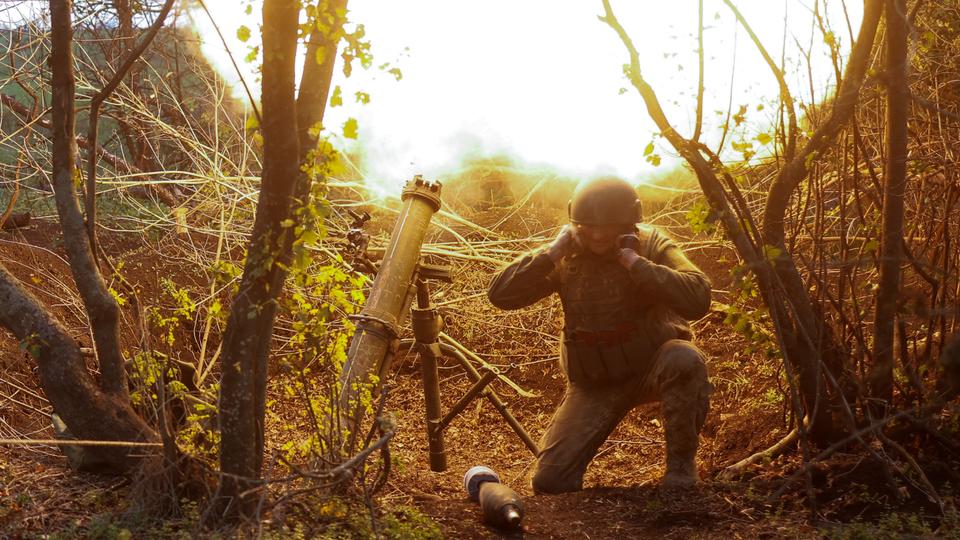 A Ukrainian serviceman fires with a mortar toward Russian positions in a frontline in the Mykolaiv region on October 28, 2022.