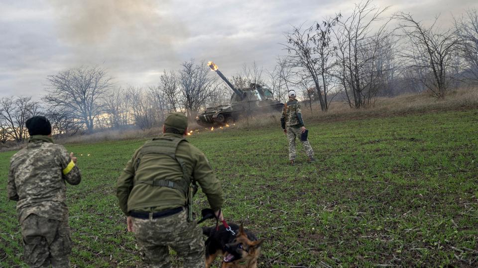 Ukrainian artillery unit members fire towards Russian position in occupied Kherson.