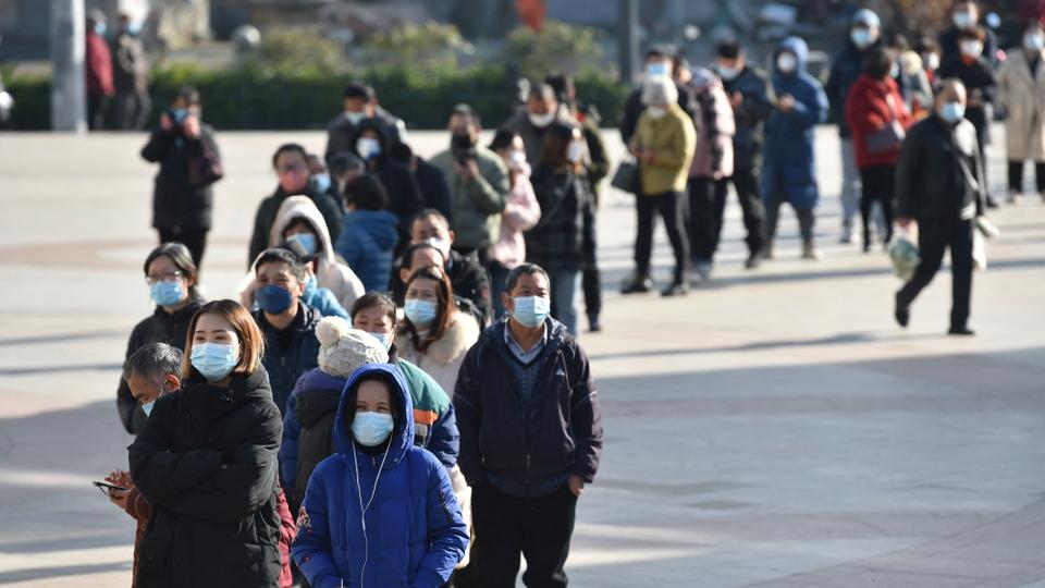 Residents line up outside a pharmacy to buy antigen testing kits for the coronavirus disease, in Nanjing, Jiangsu province, China on December 15, 2022.