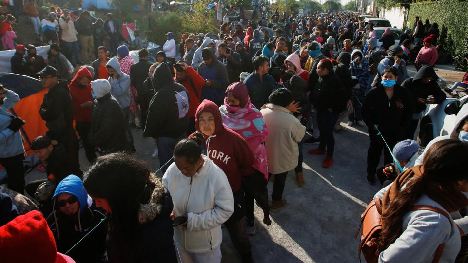 Migrants seeking asylum in the US gather at a makeshift encampment near the US border after the Supreme Court said Title 42 should be kept in place for now, in Matamoros, Mexico.