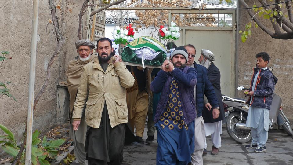 Afghan residents carry the body of Bakhretdin Khakimov during his funeral procession in Herat on December 28, 2022.