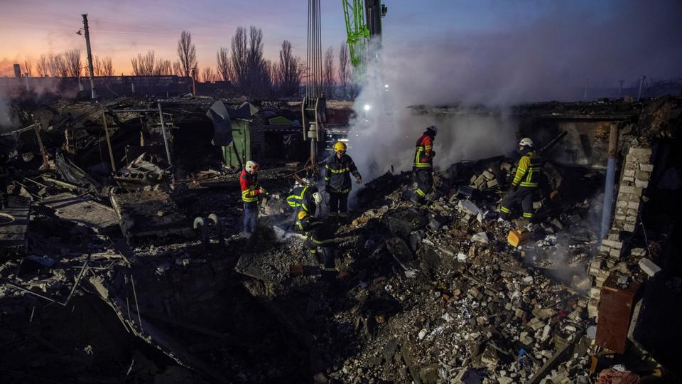 Rescuers work at an area allegedly damaged by a Russian missile strike, in Mykolaiv, Ukraine on December 31, 2022.