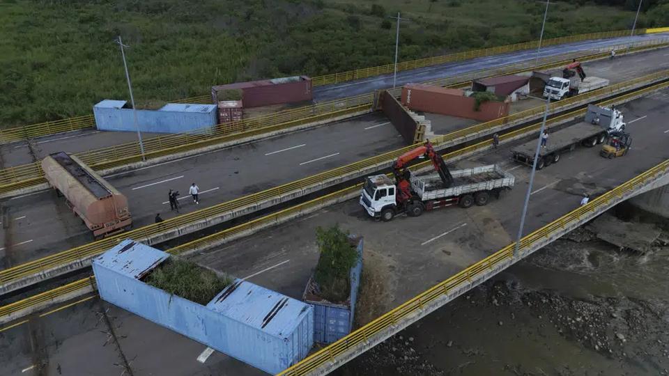 Venezuelan personnel remove containers that were blocking the Tienditas International Bridge, the international border between Venezuela and Colombia, in Cucuta, Colombia, December 15, 2022.