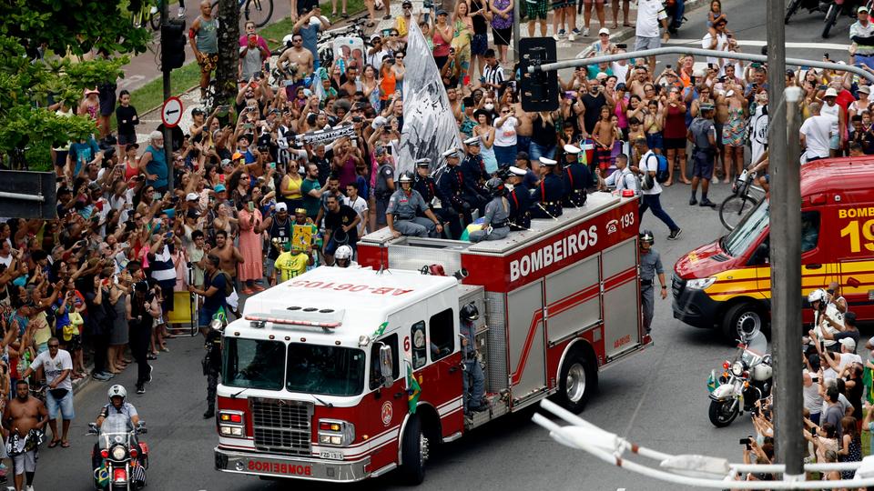 Draped in the flags of Santos and Brazil, the coffin was then hoisted to the top of a bright red fire truck for a massive funeral procession through the streets of Santos, including past the house of Pele's mother, 100-year-old Celeste Arantes.