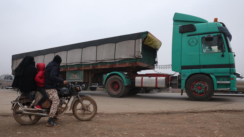 Trucks carrying aid packages from the World Food Program (WFP) drive through the rebel-held northwestern city of Idlib in Syria on Sunday.