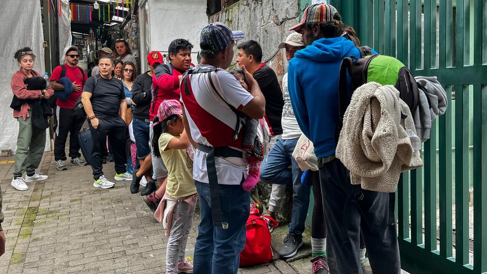 Tourists wait outside the Machu Picchu train station after the railway service was suspended due to damages allegedly caused by protesters.