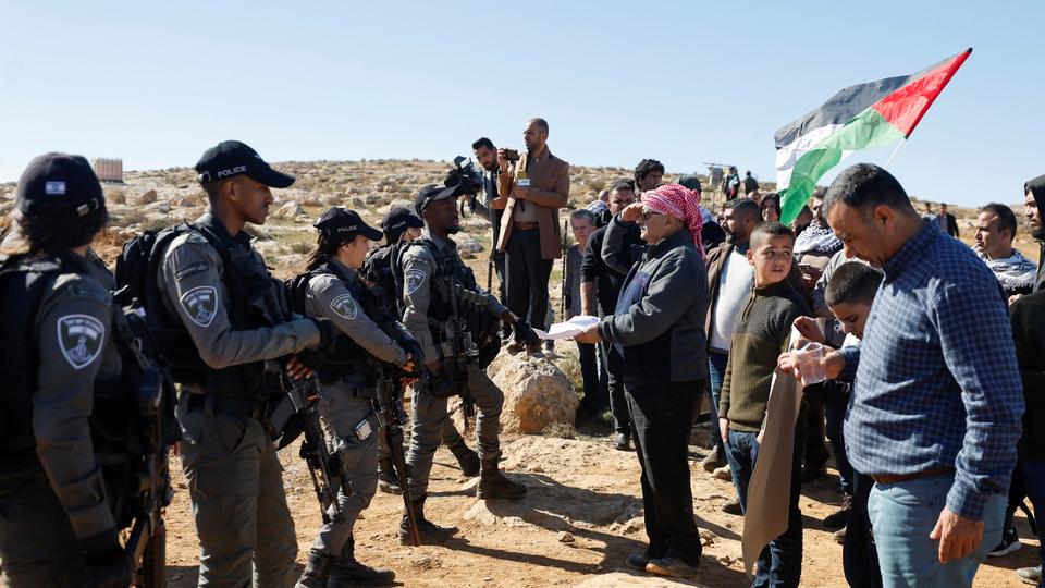 A Palestinian shows papers during a protest against illegal Jewish settlements in Masafer Yatta near Hebron, in Israeli-occupied West Bank, on January 20,2023.