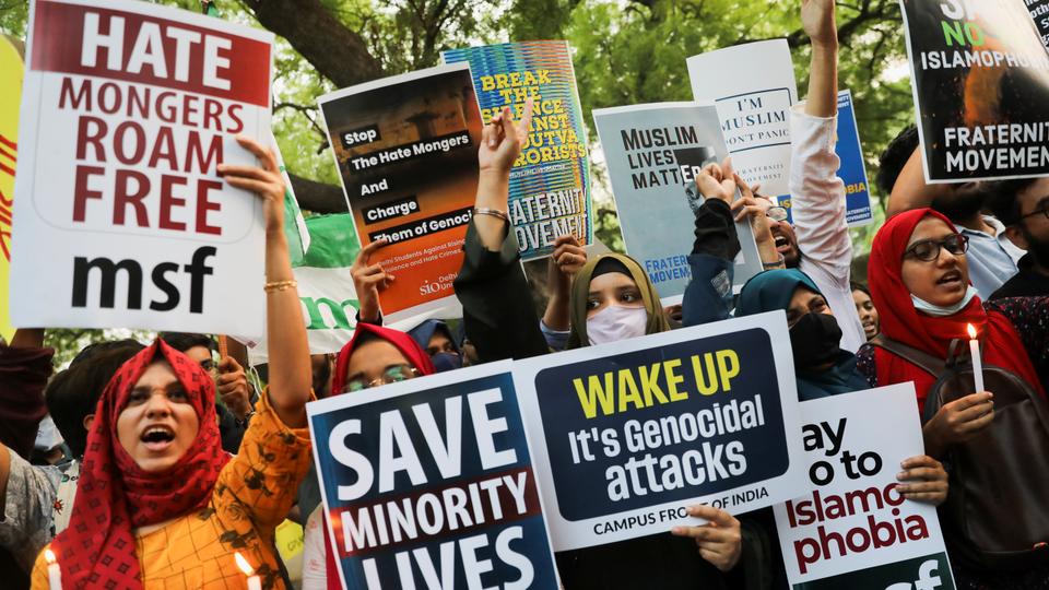 Citizens shout slogans and hold placards during a peace vigil organised by citizens against what they say is rise in hate crimes and violence against Muslims in India.