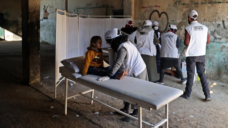 Volunteer medics set up a makeshift clinic to treat earthquake victims amid the absence of medical facilities in the rebel-held Syrian town of Jindayris on Monday.