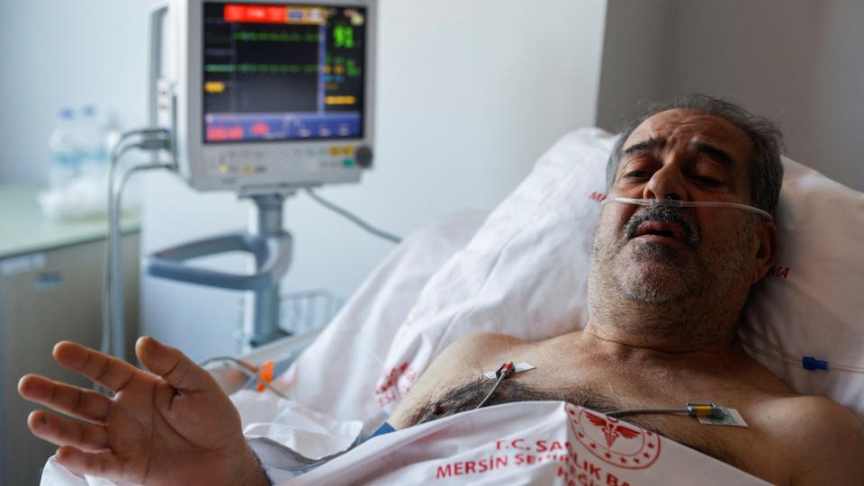 Huseyin Berber, 62, a survivor who was rescued after being trapped under the rubble for 187 hours in Antakya, speaks to media and doctors as he receives medical attention at Mersin City hospital, in the aftermath of a deadly earthquake, in Turkey, February 15, 2023.