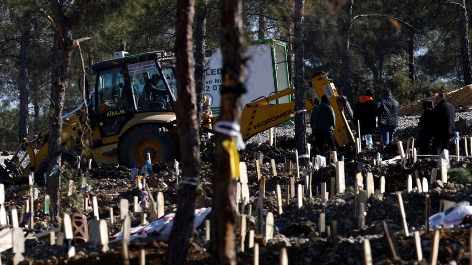 People gather for a funeral in a large graveyard, in the aftermath of the deadly earthquake outside Kahramanmaras on February 17, 2023.