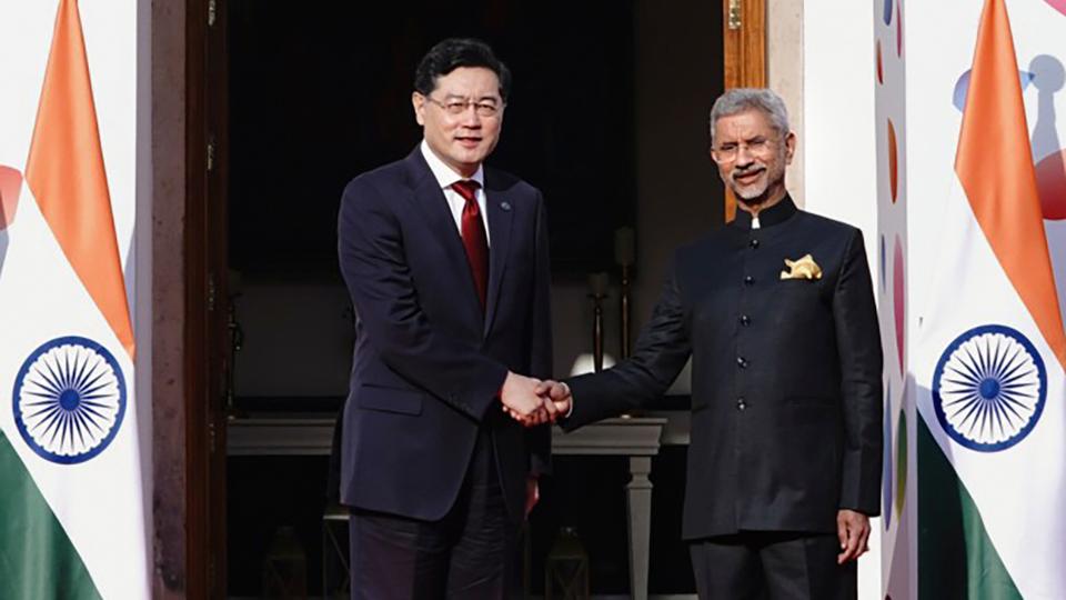 Indian foreign minister S. Jaishankar, right, welcomes his Chinese counterpart Qin Gang as the latter arrives for G20 foreign ministers meeting, in New Delhi on Thursday.