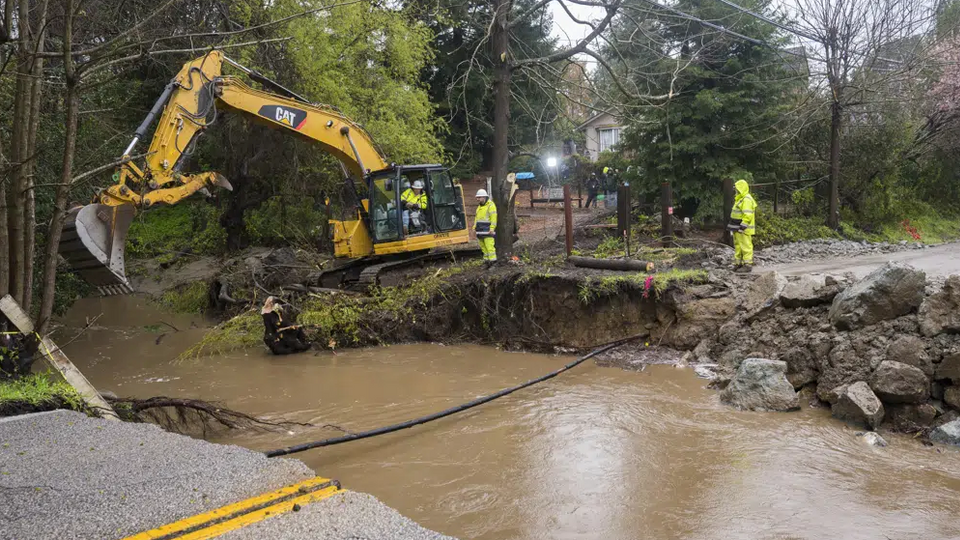 Crews assess storm damage, which washed out North Main Street in Soquel, California.