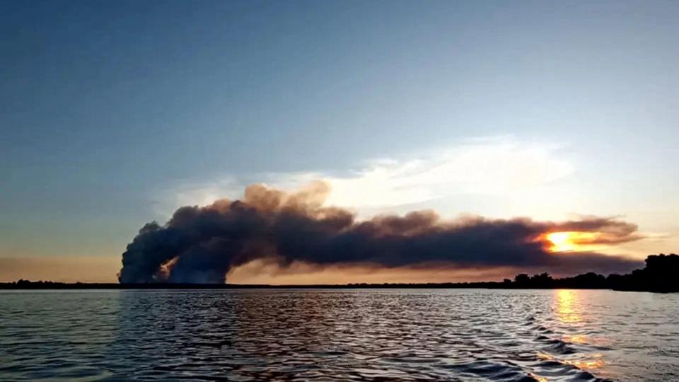 Black smoke rises from a forest plantation in Ituzaingo, Corrientes province on March 13, 2023.