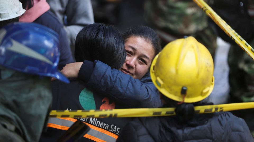 A woman reacts as rescue personnel continue the search for miners trapped following an explosion in a coal mine in Sutatausa town.