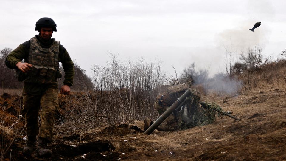 Ukrainian soldiers fire a mortar shell at a frontline position near Bakhmut in Donetsk region.