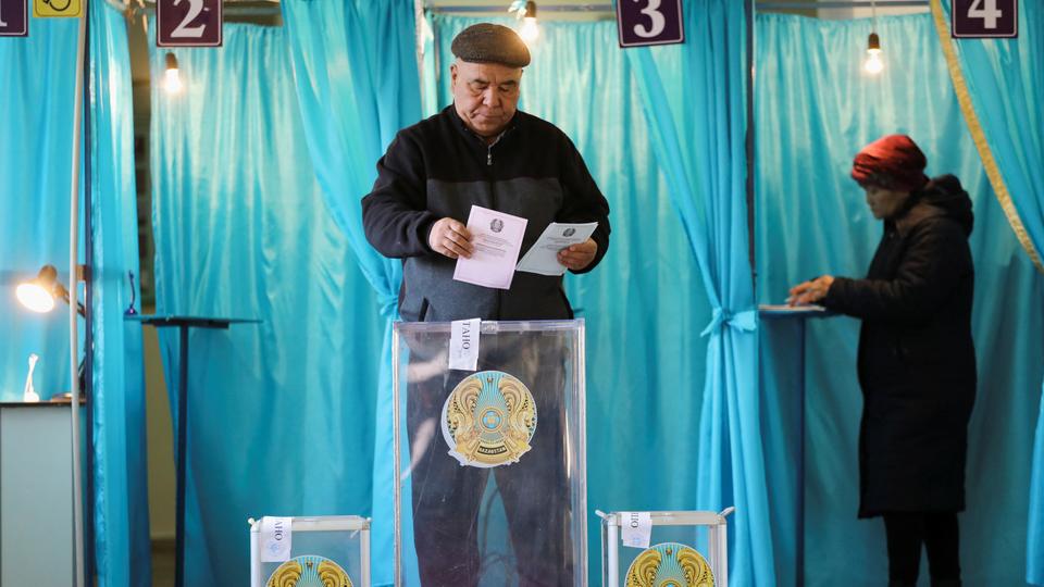 A voter casts his ballot during a parliamentary election in the village of Besagash, Kazakhstan.