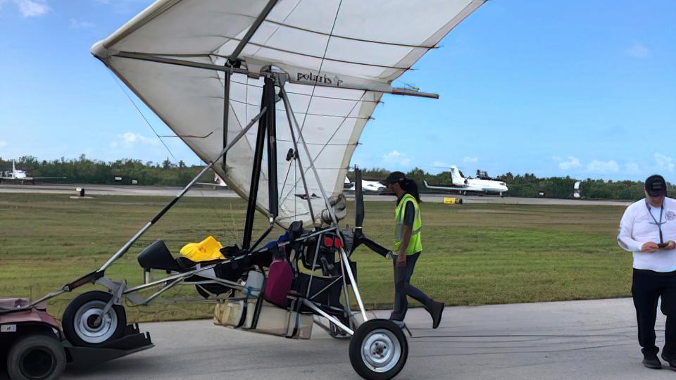 Key West International Airport personnel examine an ultralight aircraft that landed illegally at the airport carrying two Cuban men.