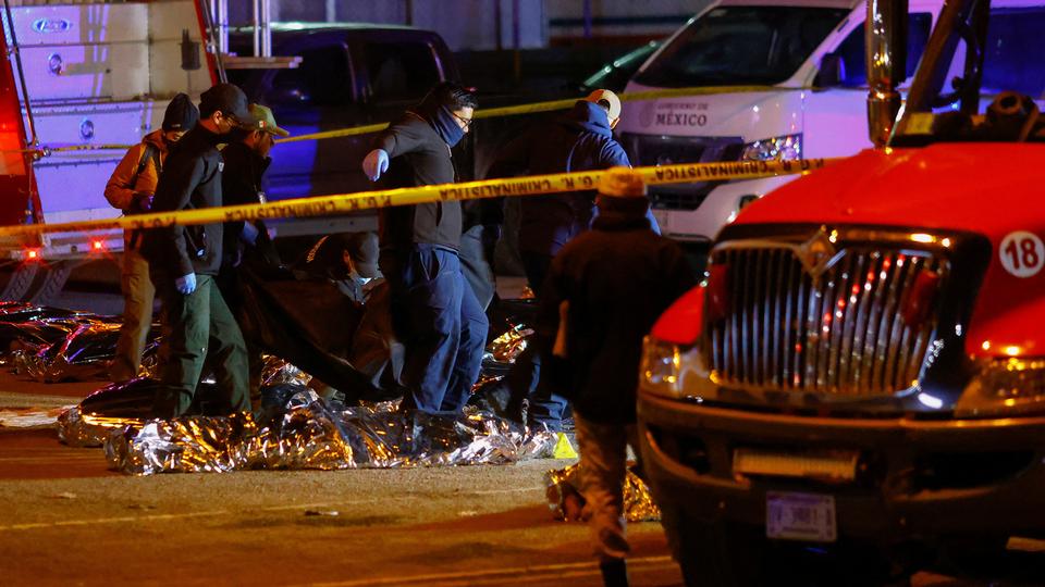 Forensic workers lift the bodies of migrants, mostly from Venezuela, who died in a fire inside the National Migration Institute (INM) building, in Ciudad Juarez, Mexico.