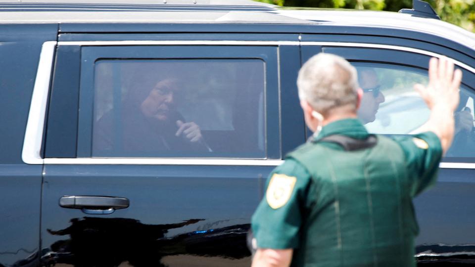 Former US President Donald Trump gestures in a vehicle as he leaves his Florida home after he was indicted by a New York City grand jury following a probe into hush money paid to porn star before the 2016 presidential elections.