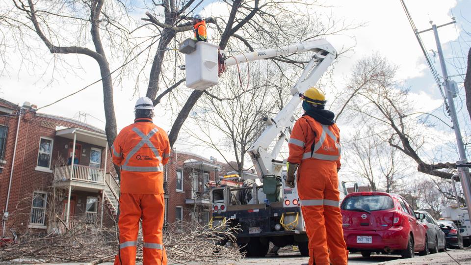 A Hydro Quebec crew works on a power line following an ice storm in Montreal.