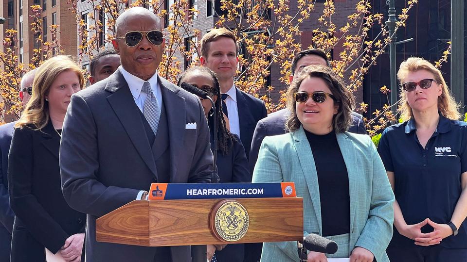 New York Mayor Eric Adams [L] introduces Kathleen Corradi [centre] as the city's first-ever citywide director of rodent mitigation, also known as the 