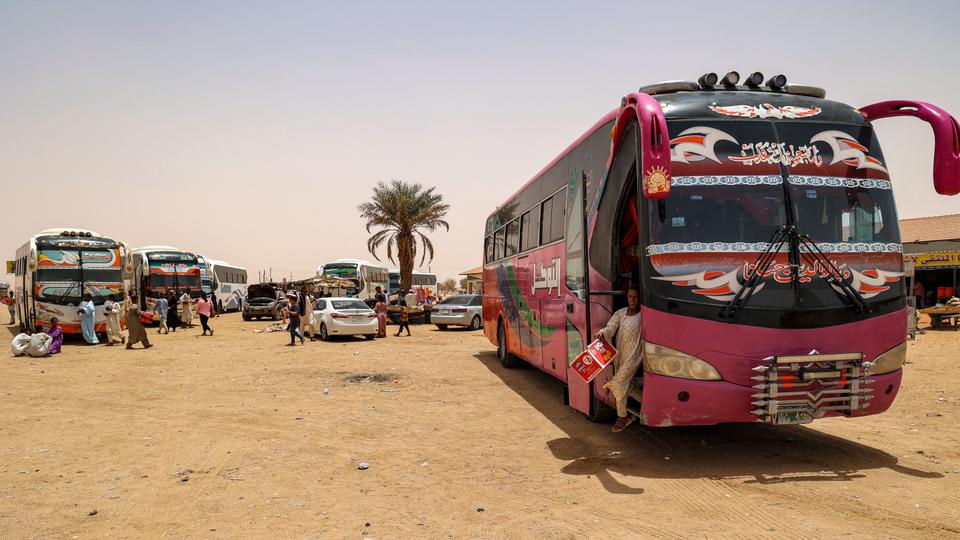 Passenger buses wait at the Multaga rest-stop near Ganetti in Sudan's Northern State on April 25, 2023, about 300 kilometres northwest of the capital, on April 25, 2023.